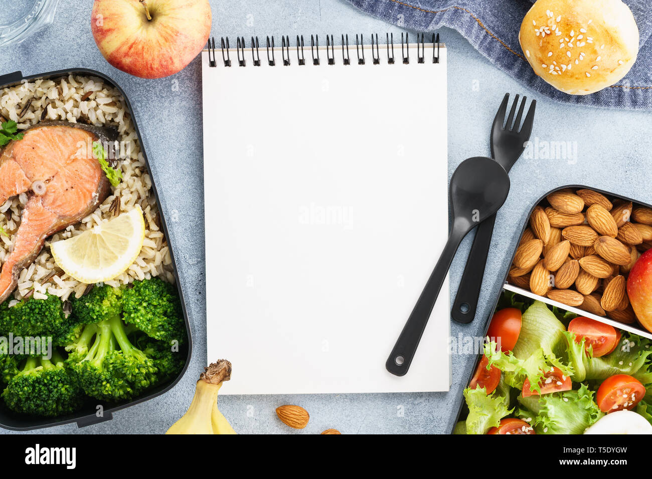 Diet plan mockup with healthy lunch boxes and empty notepad. Space for text. Flat lay. Stock Photo