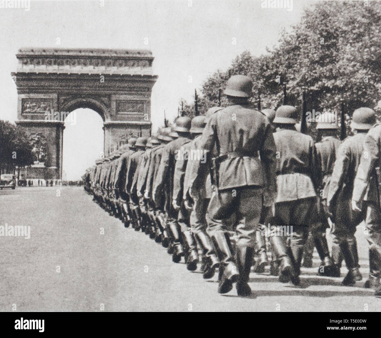 The Germans are entering Paris. The Champs-Elysees are deserted, all the houses are closed, while German units rises towards the Arc of the Star. Stock Photo