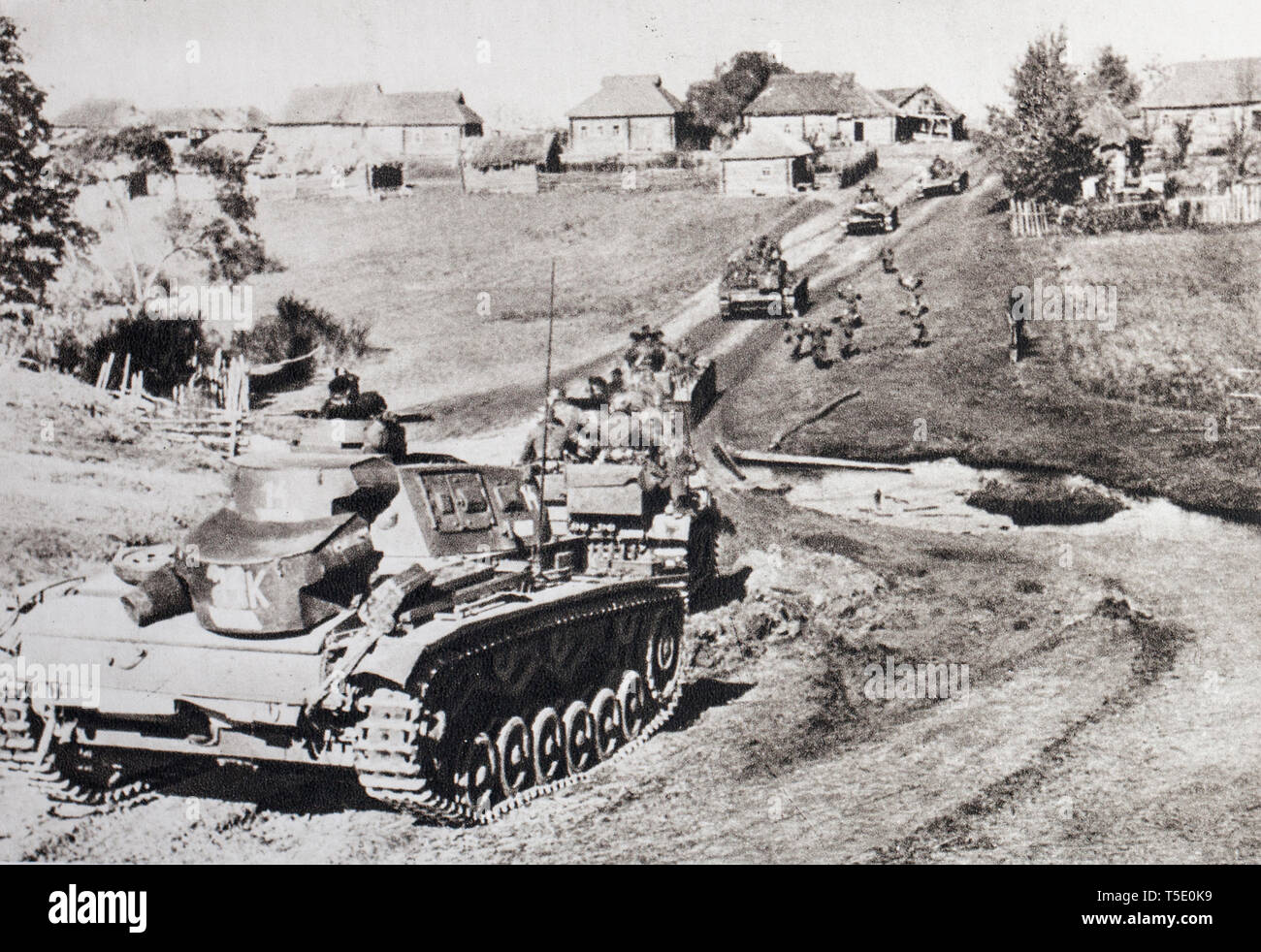 German troops on the East Front (summer 1941). A column of tanks pushes a pin of recognition. The German High Command has long anticipated victory, th Stock Photo