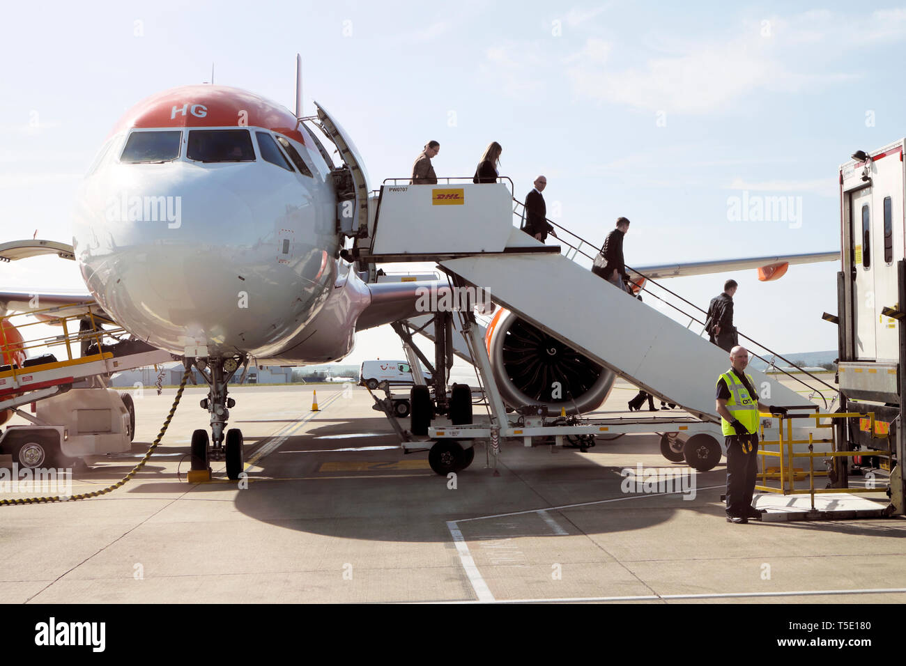 Front side view of passengers getting off leaving an Easy Jet aircraft plane on the tarmac at Bristol Airport England UK Great Britain  KATHY DEWITT Stock Photo