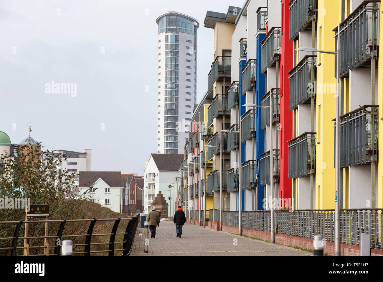 Two people walk past the flats and apartments of St Margaret's Court
