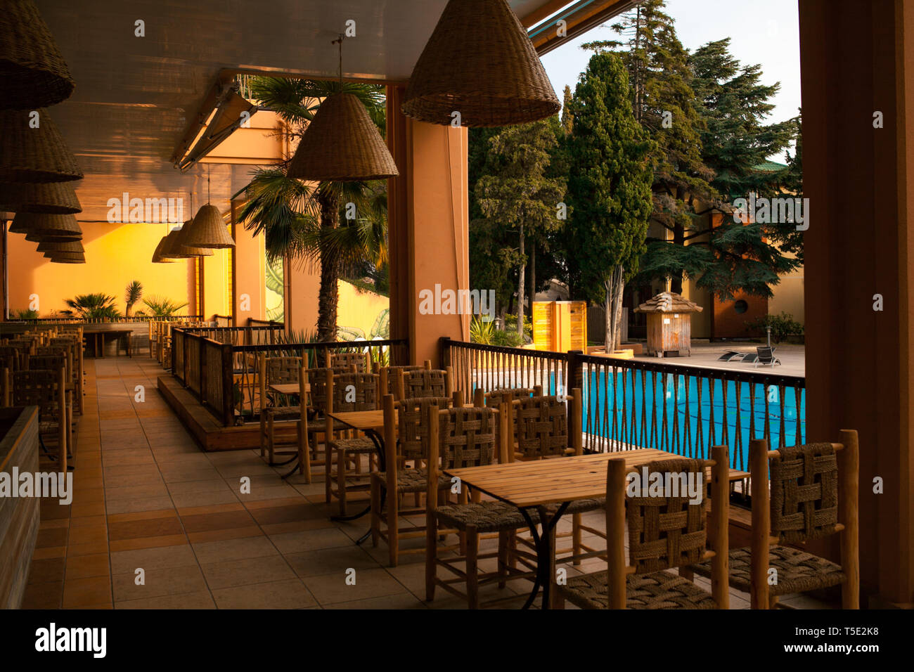 ALUSHTA, CRIMEA, UKRAINE - JANUARY 19, 2019: Luxury outdoor swimming pool with palm tree. Travel and relaxing. Stock Photo