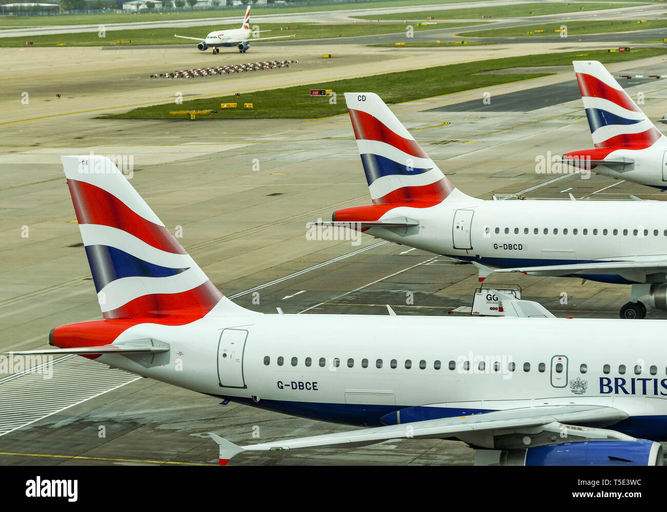 LONDON GATWICK AIRPORT, ENGLAND APRIL 2019 Tail fins of three