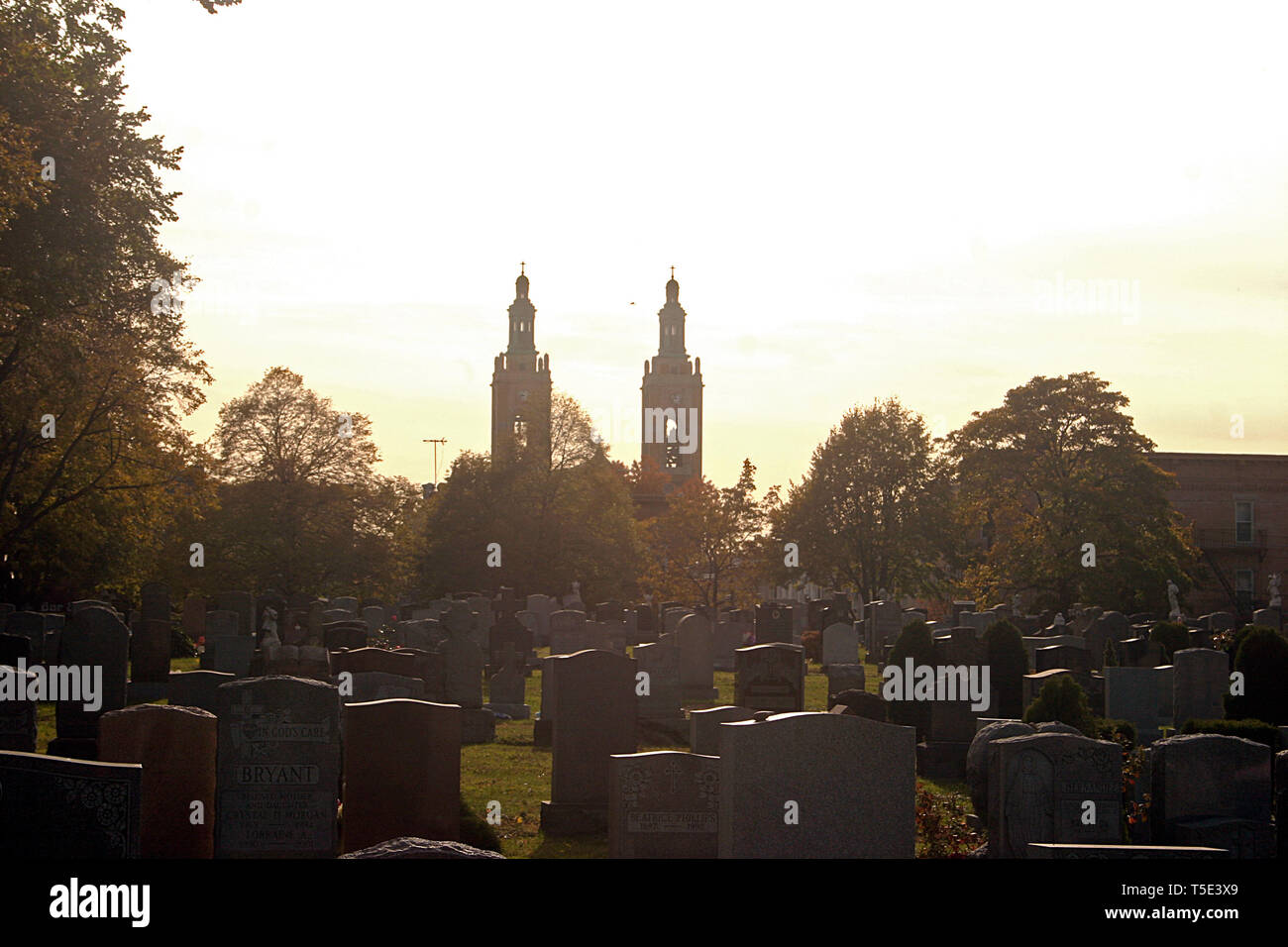 Ridgewood, NY, USA. Linden Hill Methodist Cemetery, with view of St Aloysius Roman Catholic