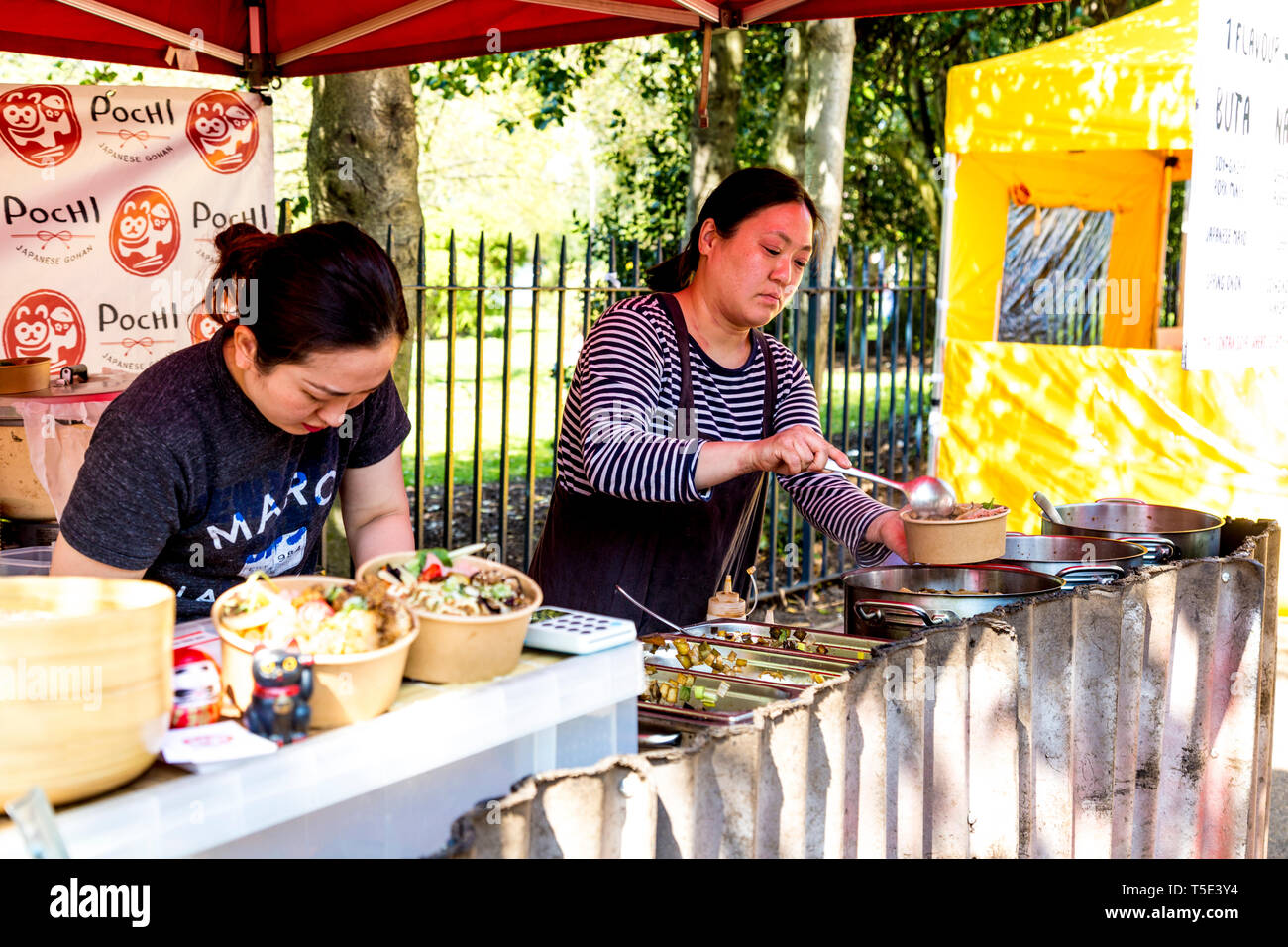 Japanese street food Pochi, woman serving bento rice bowls at Victoria Park Market, London, UK Stock Photo