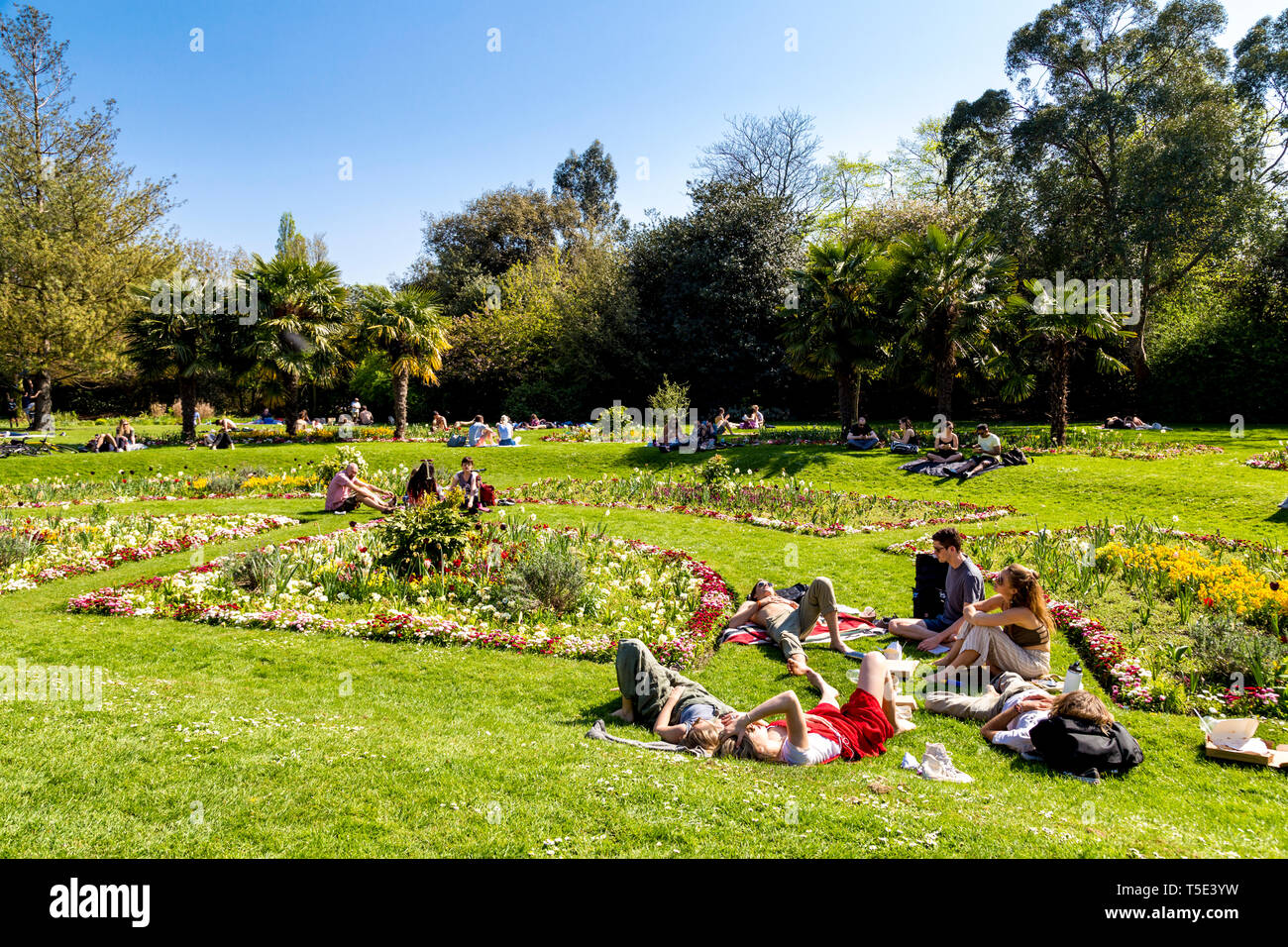21st April 2019 - People sitting in the sun during Bank Holiday heatwave in Victoria Park, London, UK Stock Photo