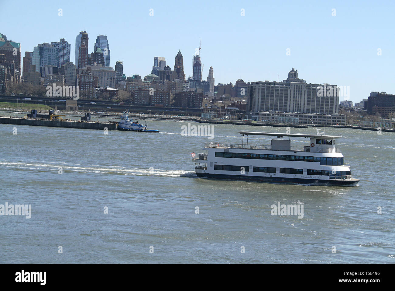 Cruise Boat And Tugboat In The New York Bay With View Of