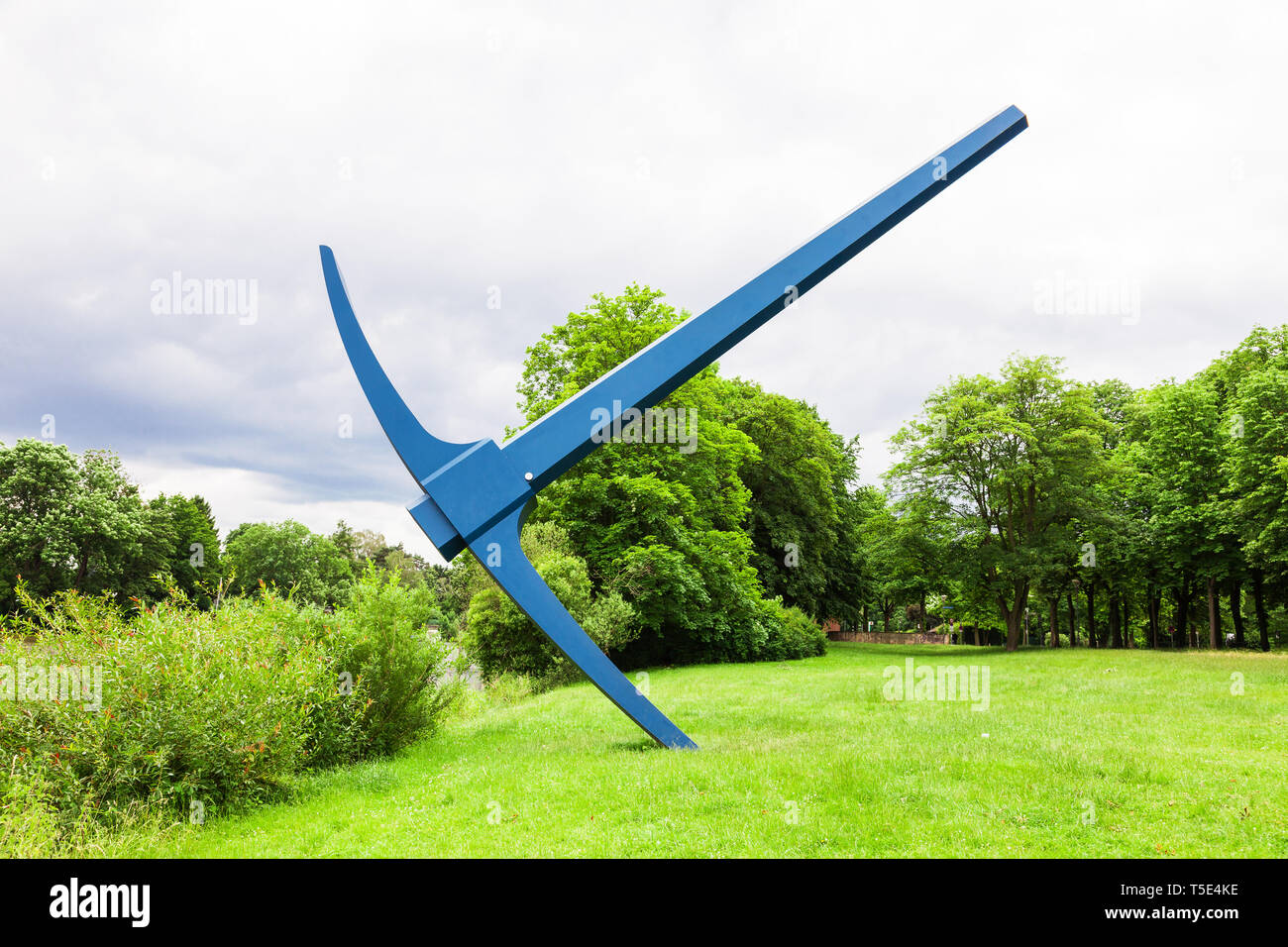 Huge pick axe in front of a river Stock Photo