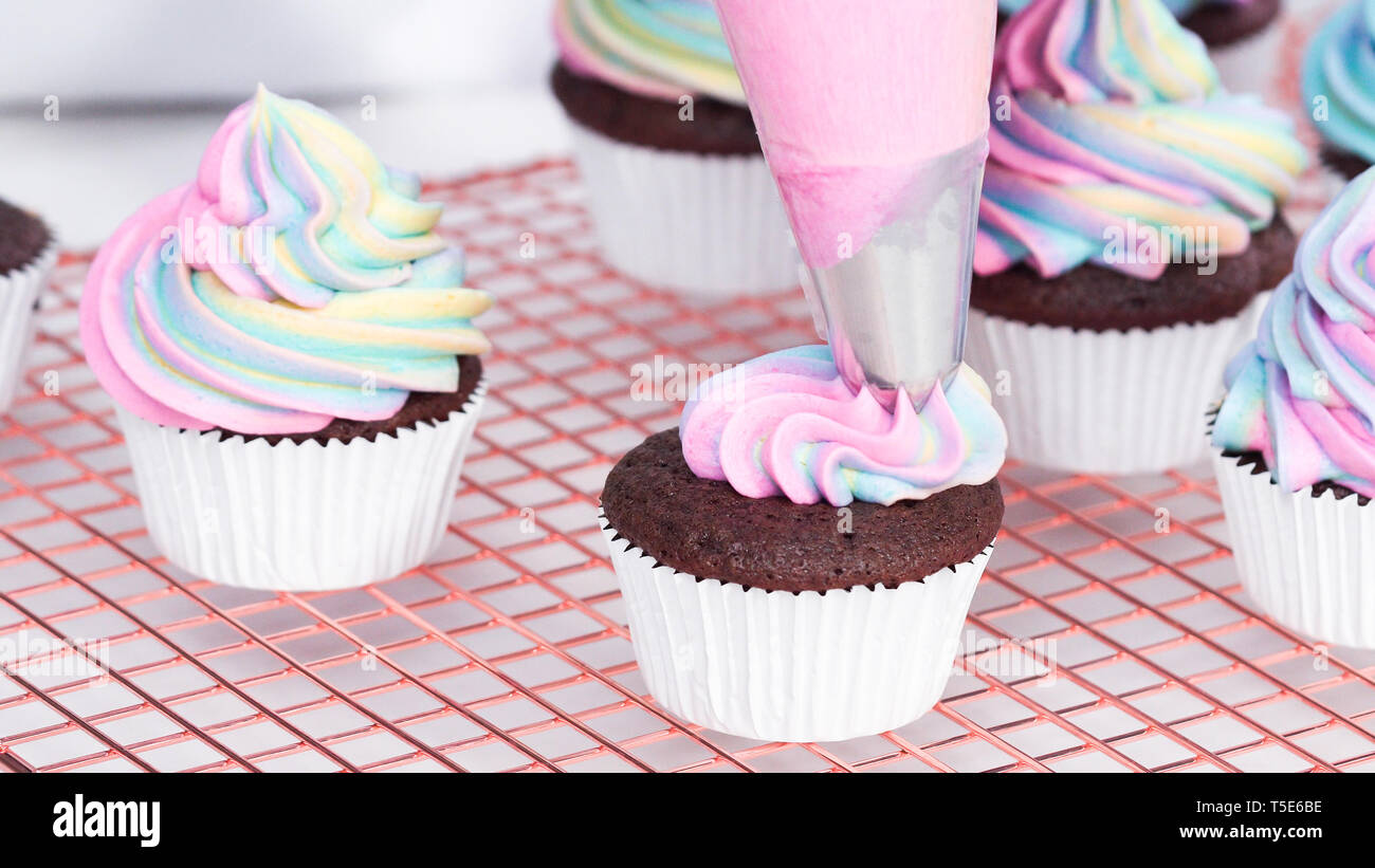 Step by step. Scooping batter with a cupcake scoop to make unicorn  chocolate cupcakes with buttercream frosting Stock Photo - Alamy