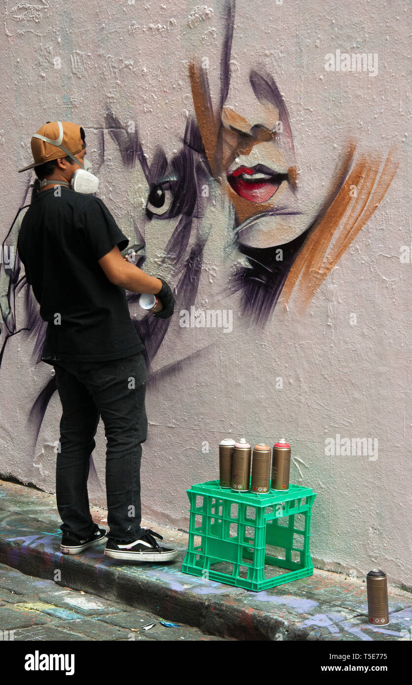 Street artist working in Hosier Lane, Melbourne, Australia Stock Photo