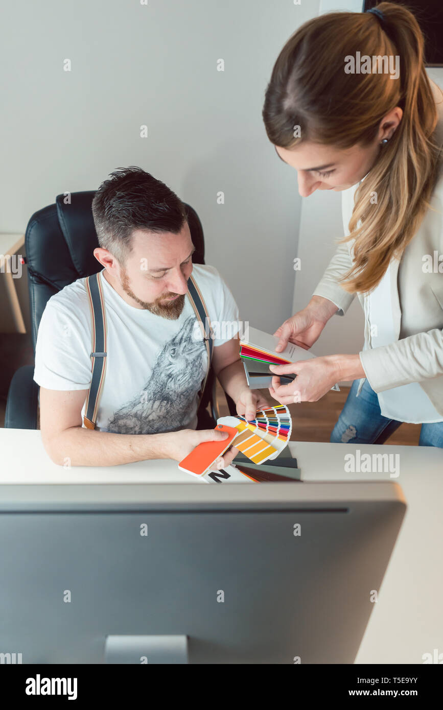 Creatives working in team checking colors for advertising project Stock Photo