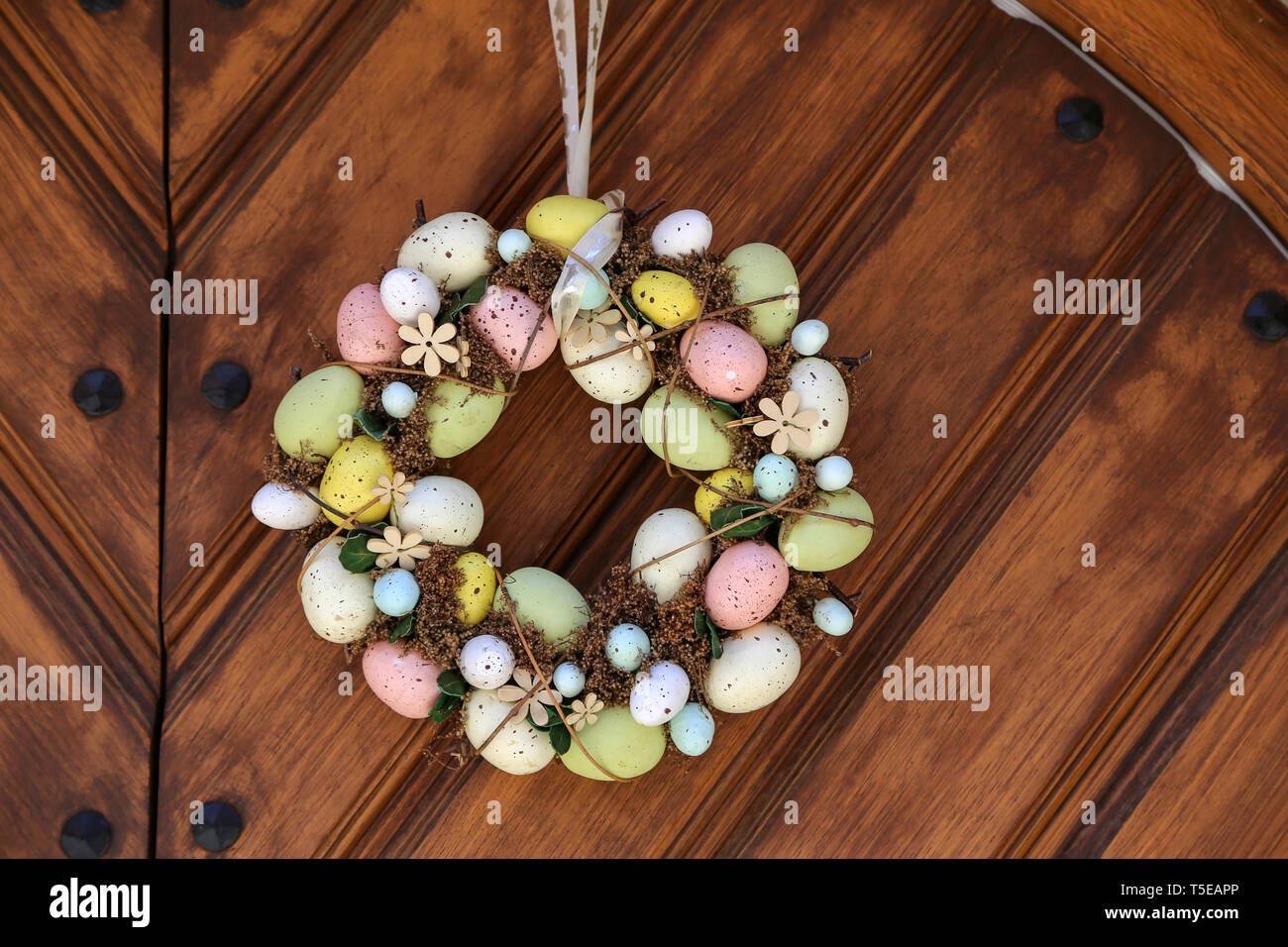 Easter egg wreath hangs on the door. Stock Photo