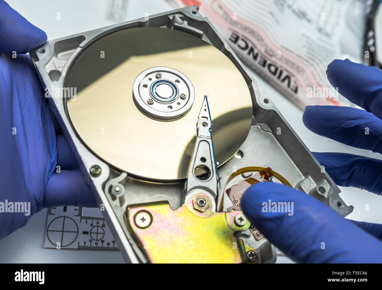 Police expert examines hard drive in search of evidence, conceptual image Stock Photo