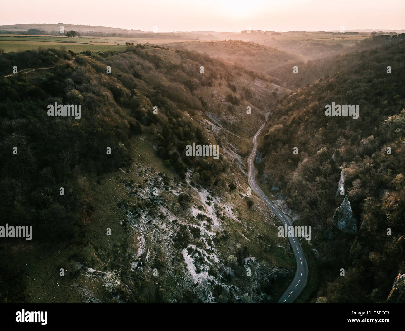 Aerial drone photo of Cheddar Gorge, Somerset UK. Taken at sunrise to capture the warmth of the light coming through the gorge and light on the rocks Stock Photo