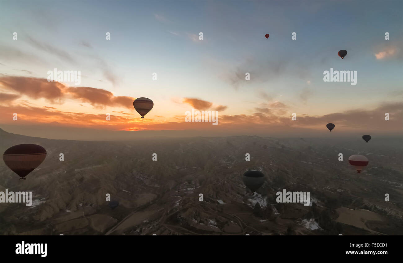 Aerial view of Cappadocia at sunrise with hot air balloons flying Stock ...