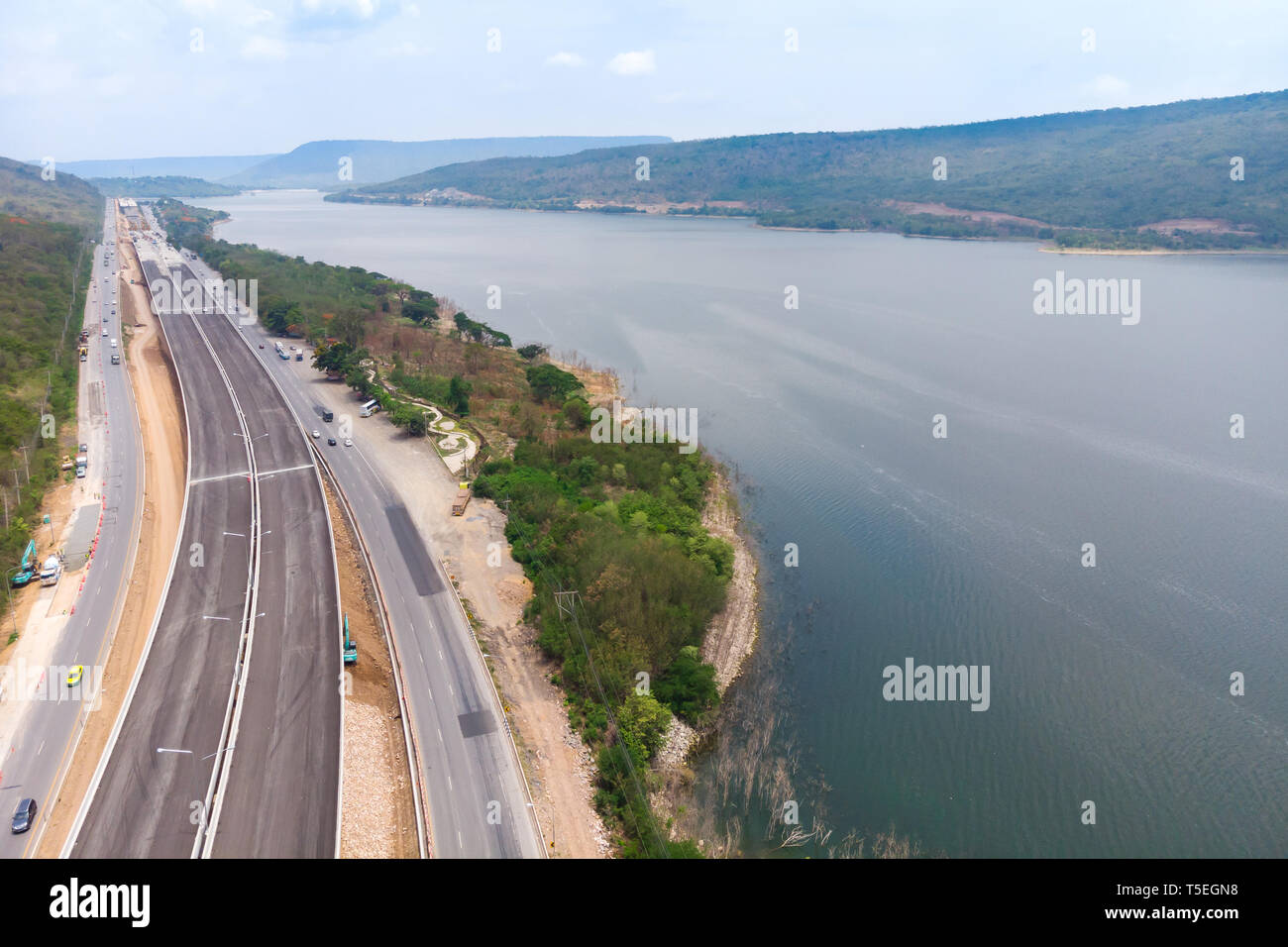 Drone shot aerial view landscape of under construction motorway tolls near big natural river Stock Photo