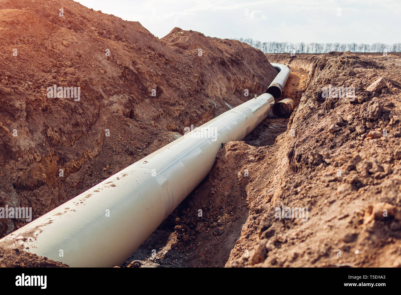 Industrial gas pipeline. Laying new pipes in field underground. Outdoor