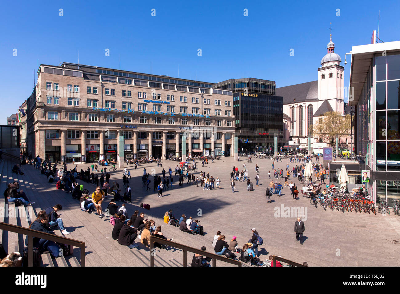 Germany, Cologne, the square in front of the main station, Deichmannhaus and church St. Mariae Himmelfahrt.  Deutschland, Koeln, der Bahnhofsvorplatz, Stock Photo