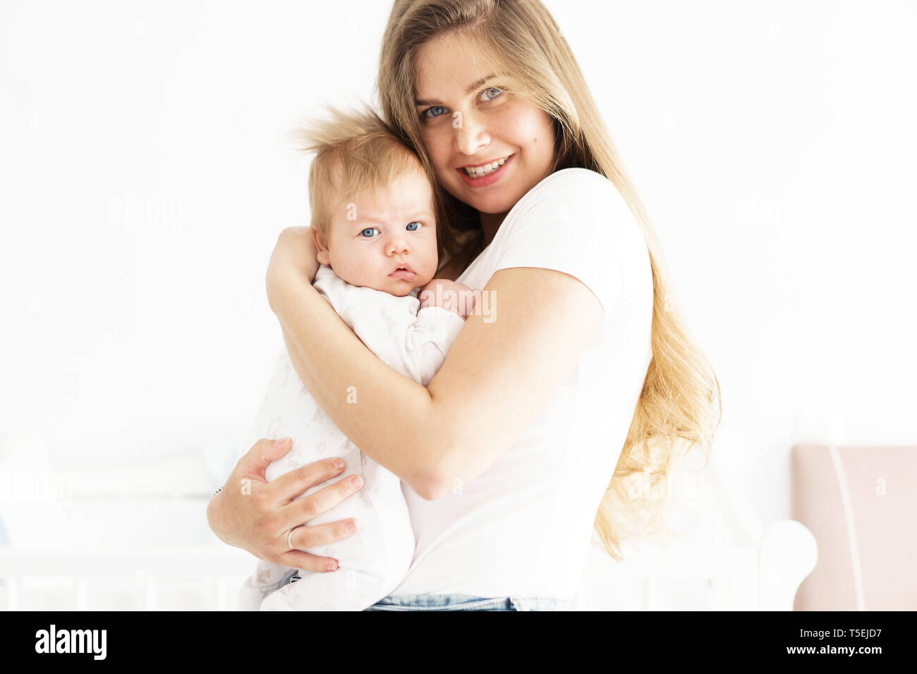 Mom and newborn son in her arms. The concept of new life, love and helplessness. Lips bow Stock Photo