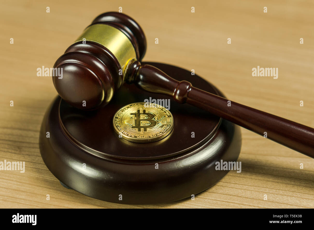 Bitcoin Regulation. BTC crypto coin and gavel on a desk. Stock Photo