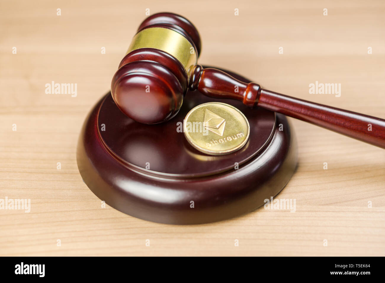 Ethereum Regulation. ETH crypto coin and gavel on a desk. Stock Photo