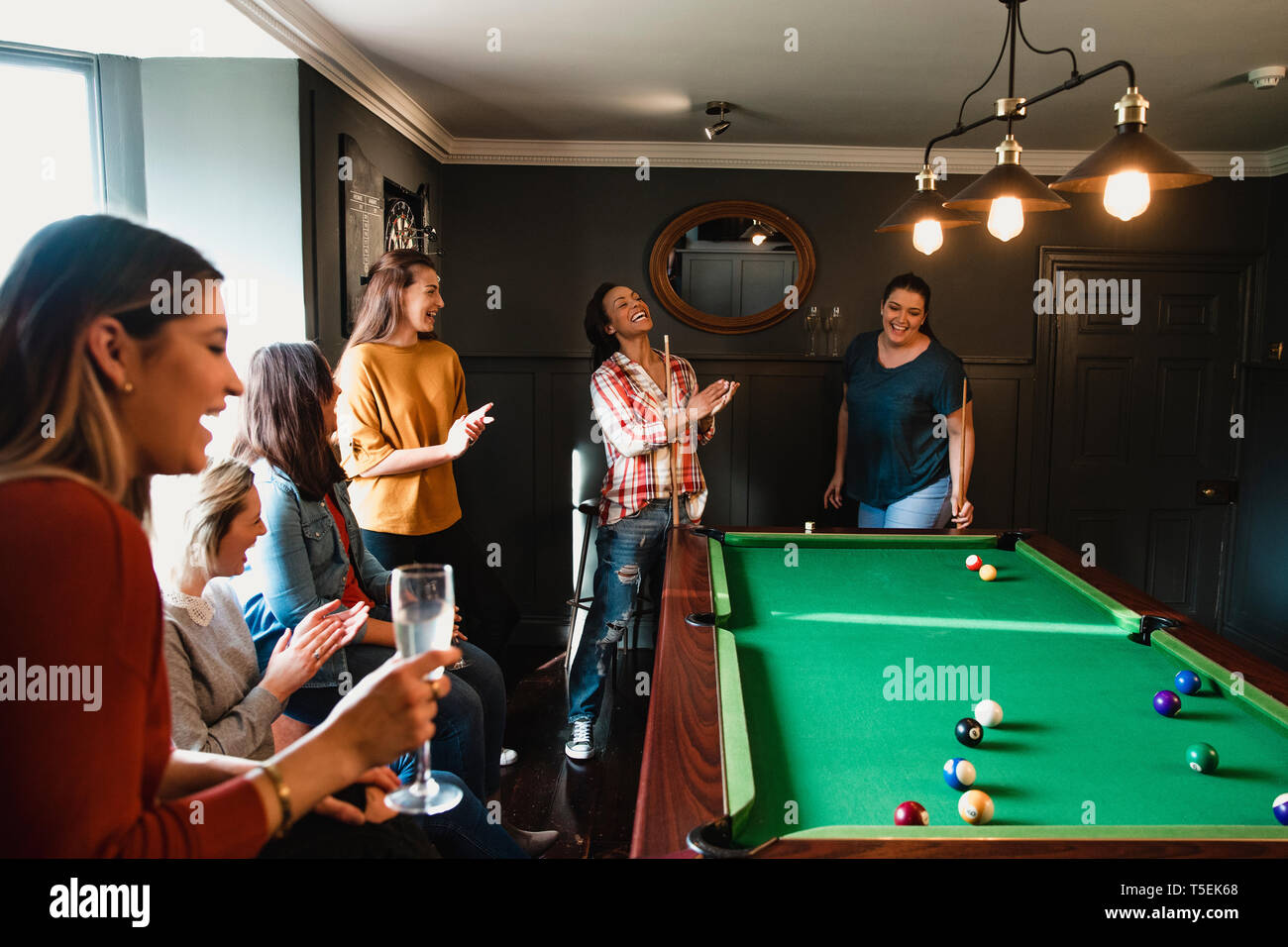 Billiards game. young friends playing pool together Stock Photo - Alamy