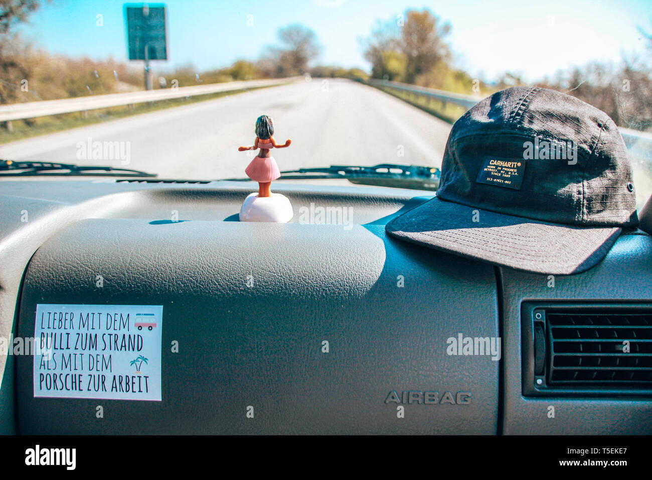 Blick aus dem Auto auf die Straße mit Sticker und Hoola-Girl auf der Ablage  Stock Photo - Alamy