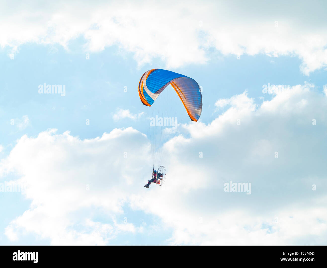 One man practicing extreme sport with paraglider with motor Stock Photo