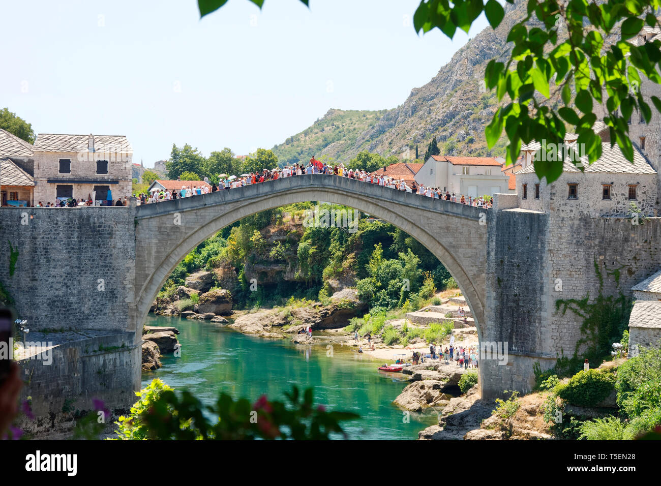Stari Most; Old Bridge; 16 century Ottoman structure, River Neretva; arched design; UNESCO World Heritage site; crowded with people, Mostar; Bosnia He Stock Photo
