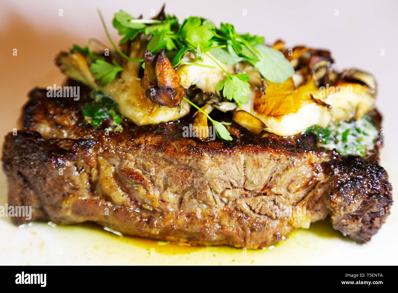 A succulent ribeye steak. The meat is served medium-rare Stock Photo ...