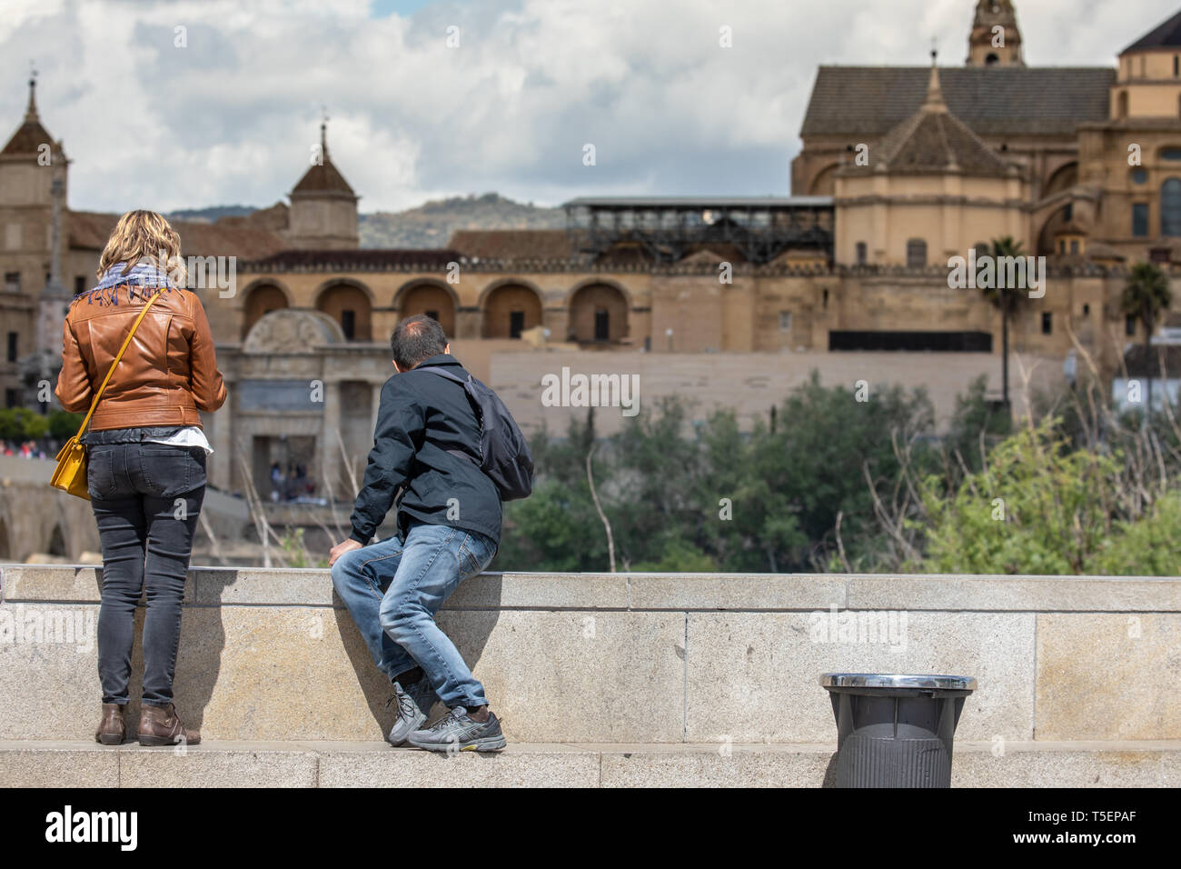 Cordoba, Spain - April 23, 2019: Tourist couple in Cordoba looking at the Mosque in front of them Stock Photo