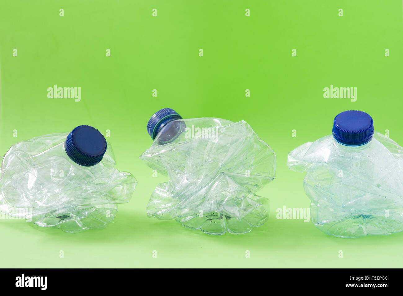 Disposable waste plastic bottle on green background Stock Photo