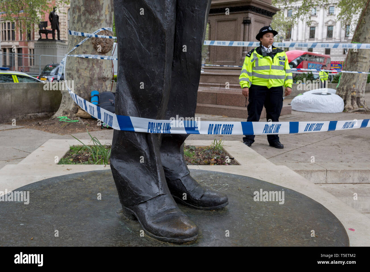 On the 10th consecutive day of protests around London by the climate change campaign Extinction Rebellion, police tape wrapped around the statue of Nelson Mandela and bars entry beneath tree protesters, on 24th April 2019, in Parliament Square, Westminster, London England. Stock Photo