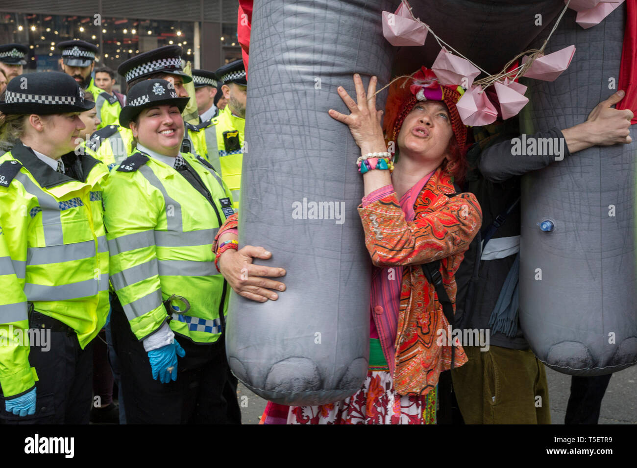 On the 10th consecutive day of protests around London by the climate change campaign Extinction Rebellion, a large inflatable elephant allows humour among protesters and police officers, on 24th April 2019, at Marble Arch, London England. Stock Photo