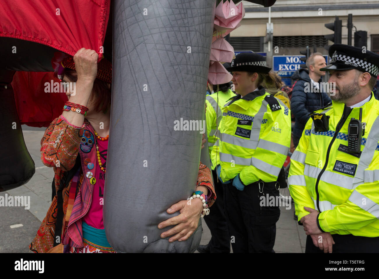 On the 10th consecutive day of protests around London by the climate change campaign Extinction Rebellion, a large inflatable elephant allows humour among protesters and police officers, on 24th April 2019, at Marble Arch, London England. Stock Photo