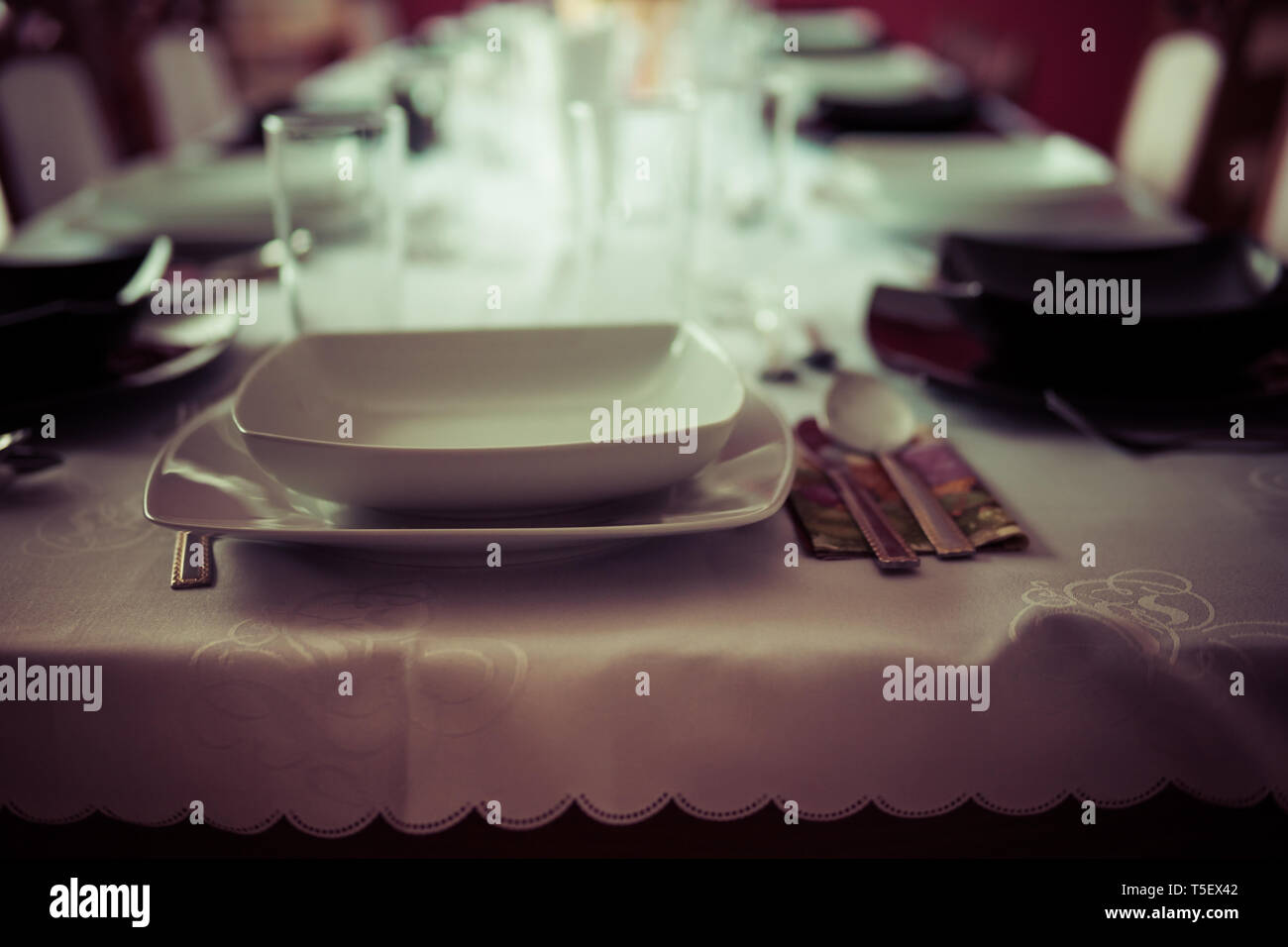 elegant table setting with decoration for dinner in regular home Stock Photo