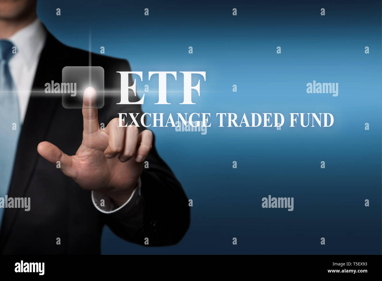 business finance concept - businessman presses virtual touchscreen button - ETF Exchange Traded Fund Stock Photo
