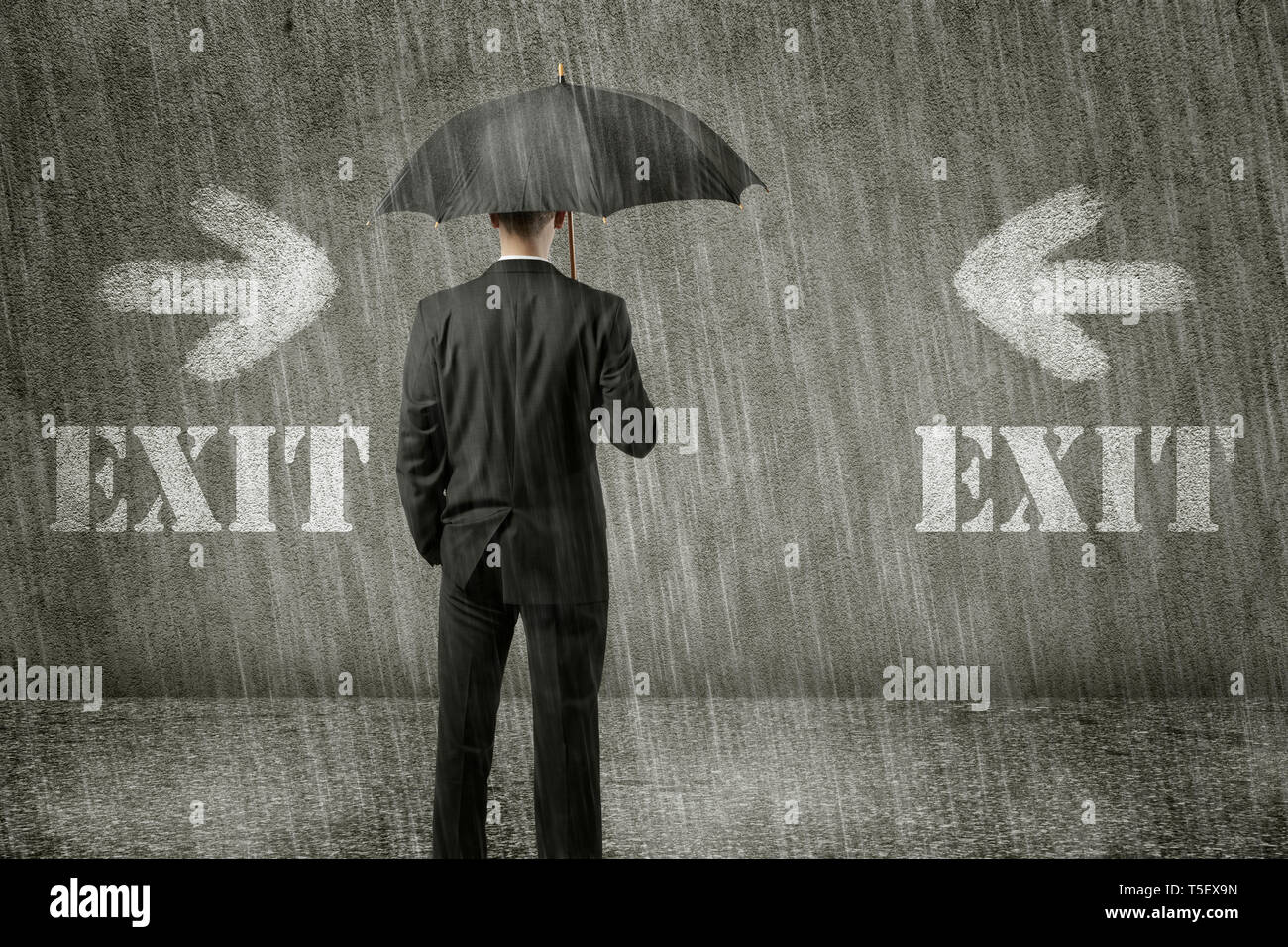 Trapped unhappy businessman is standing in front of wall on a gloomy day and has no way out of his hopeless situation - business concept Stock Photo