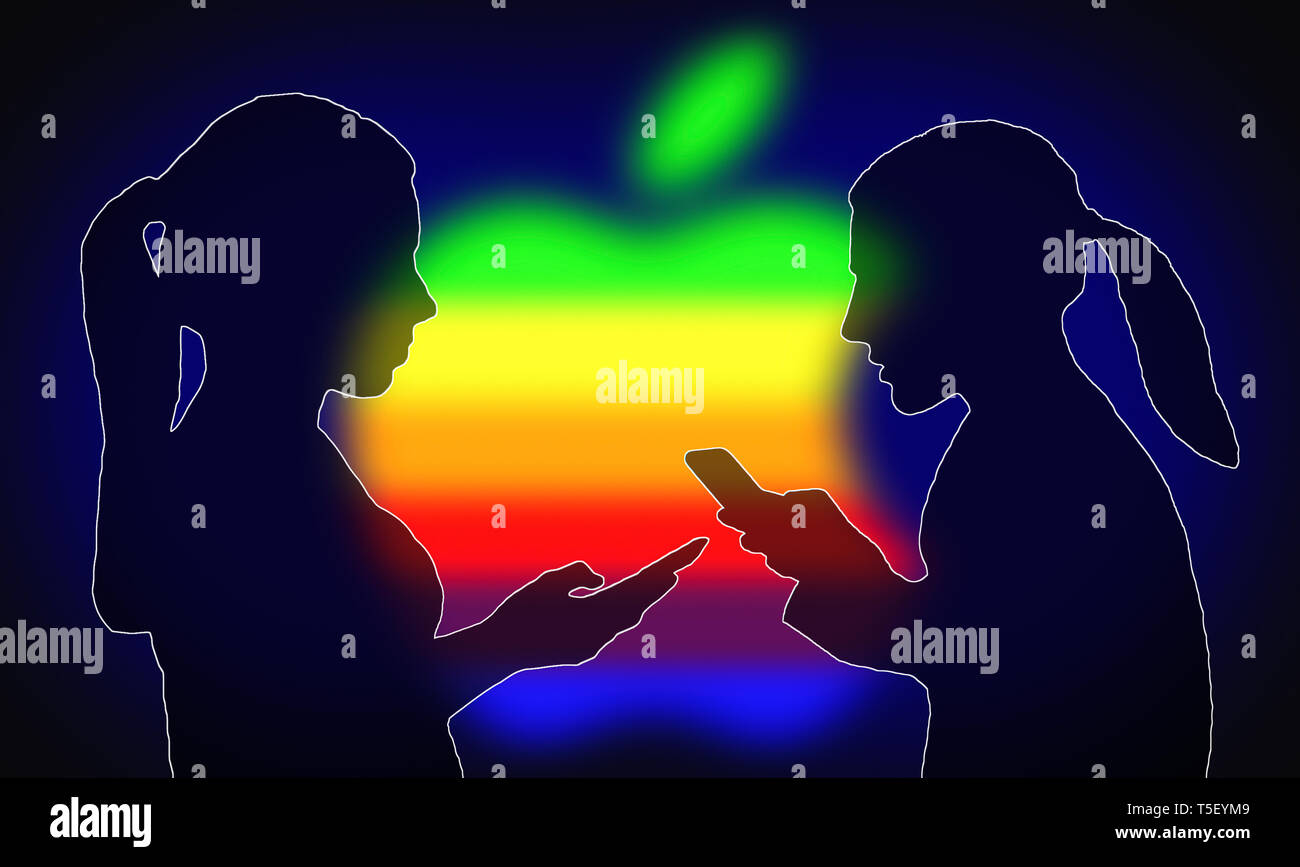 Silhouettes of a pair of women using iPhones or other Apple products with the Apple company logo in the background. Stock Photo