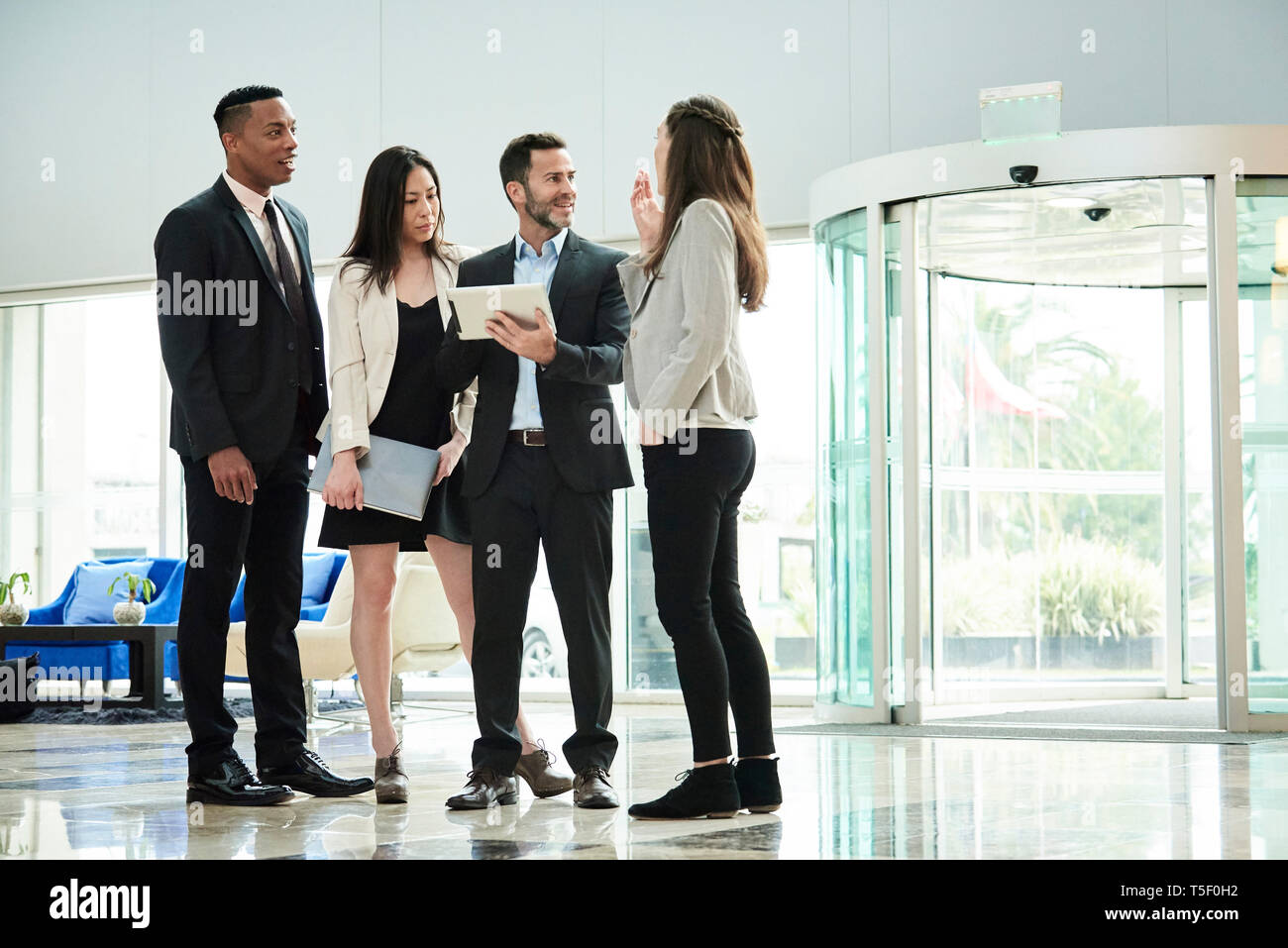 Business people standing and discussing in the hotel lobby Stock Photo ...
