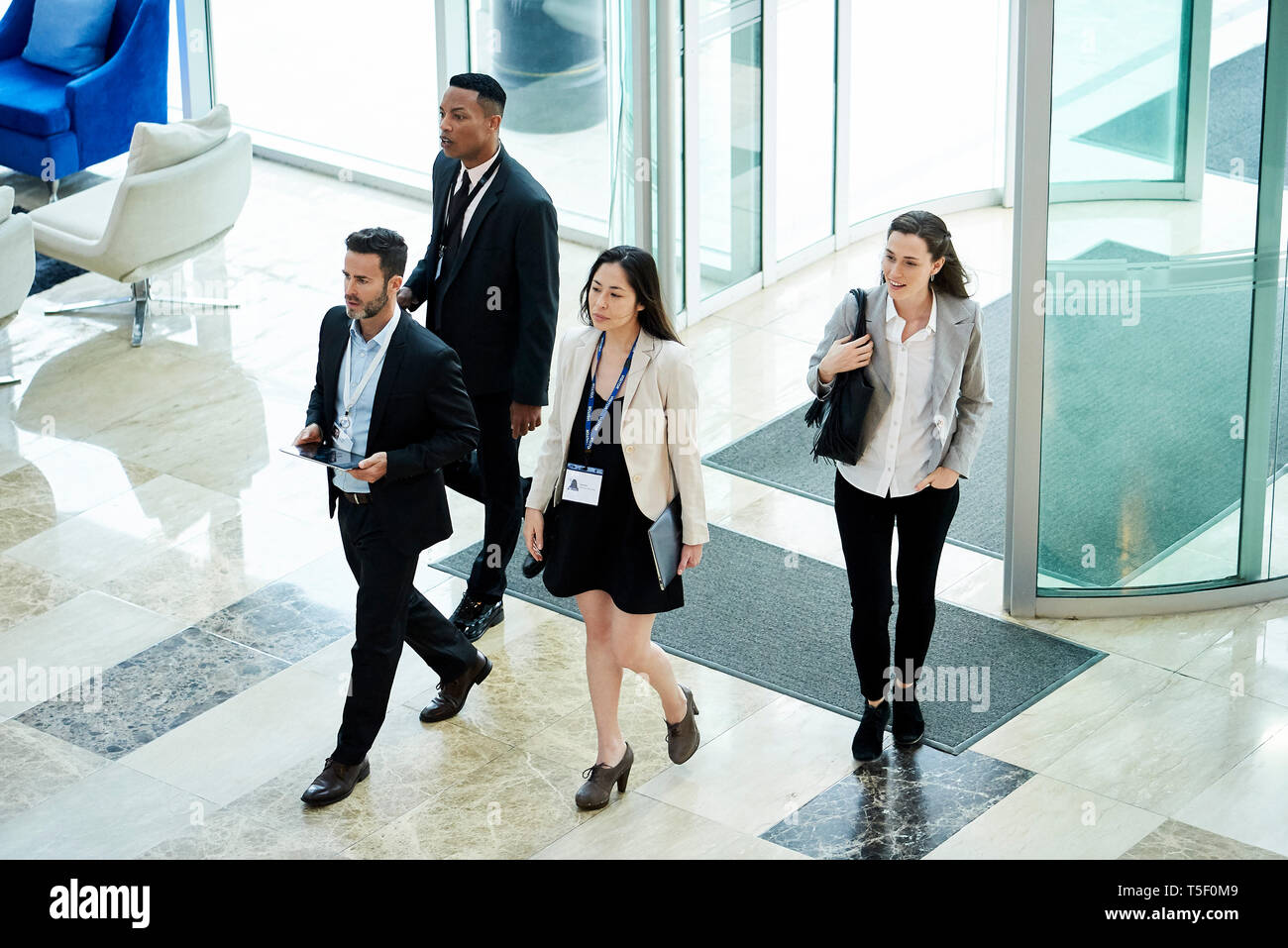 Business people entering hotel lobby Stock Photo - Alamy