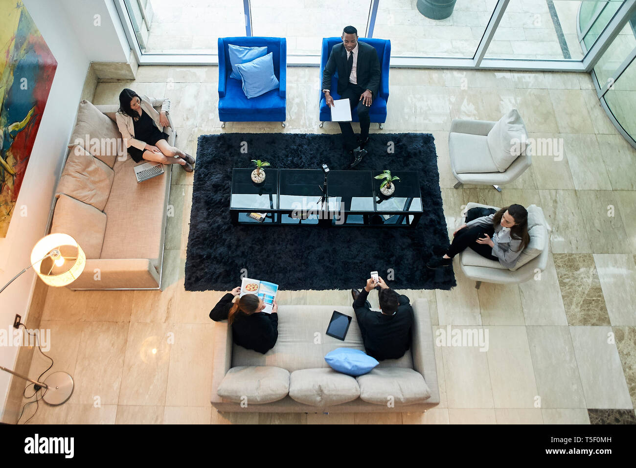 Business people talking in hotel lobby Stock Photo - Alamy
