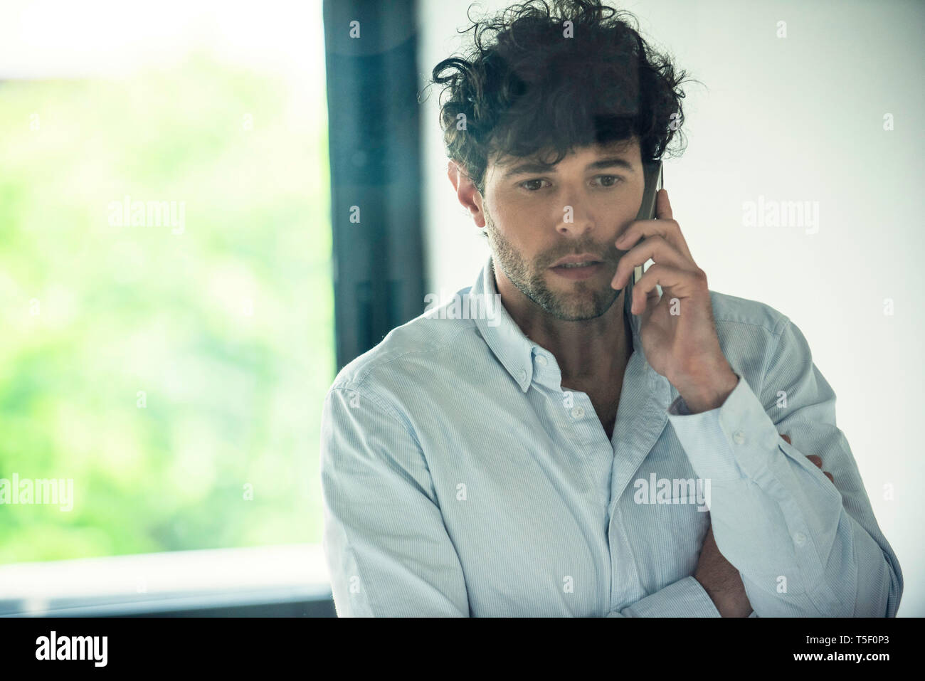 Businessman talking on smartphone Stock Photo