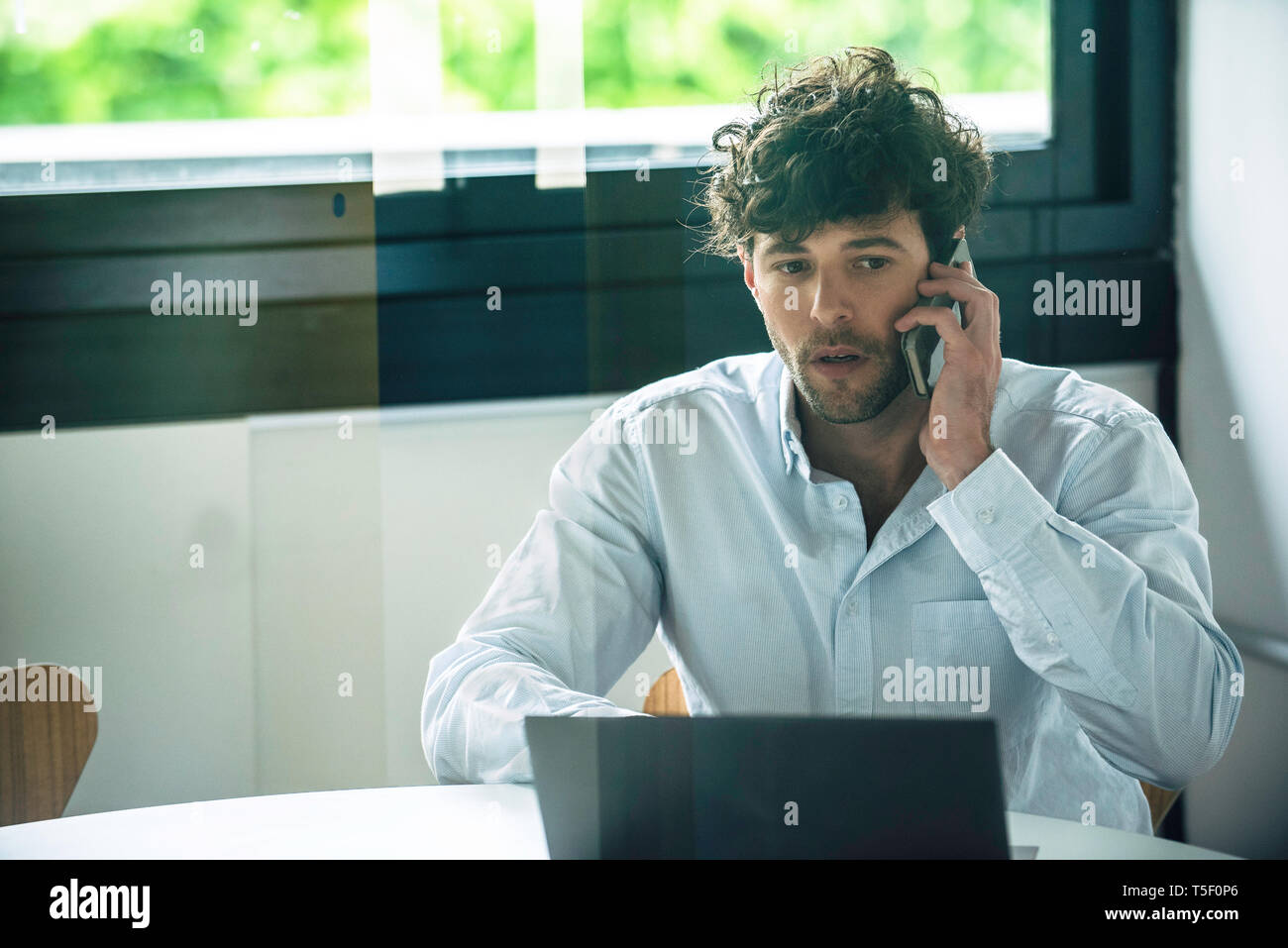 Businessman talking on smartphone Stock Photo