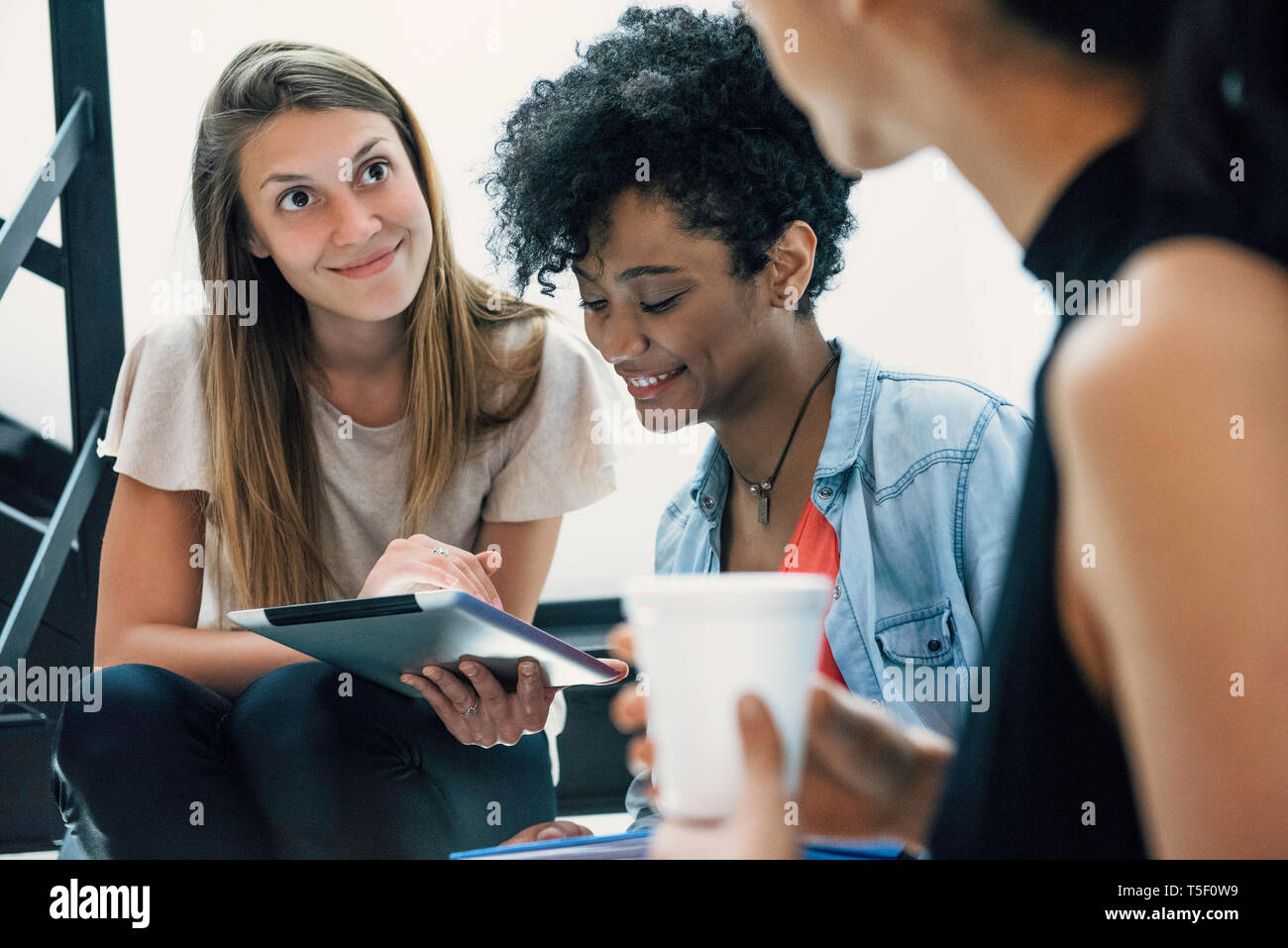 Businesswomen using digital tablet in office Stock Photo