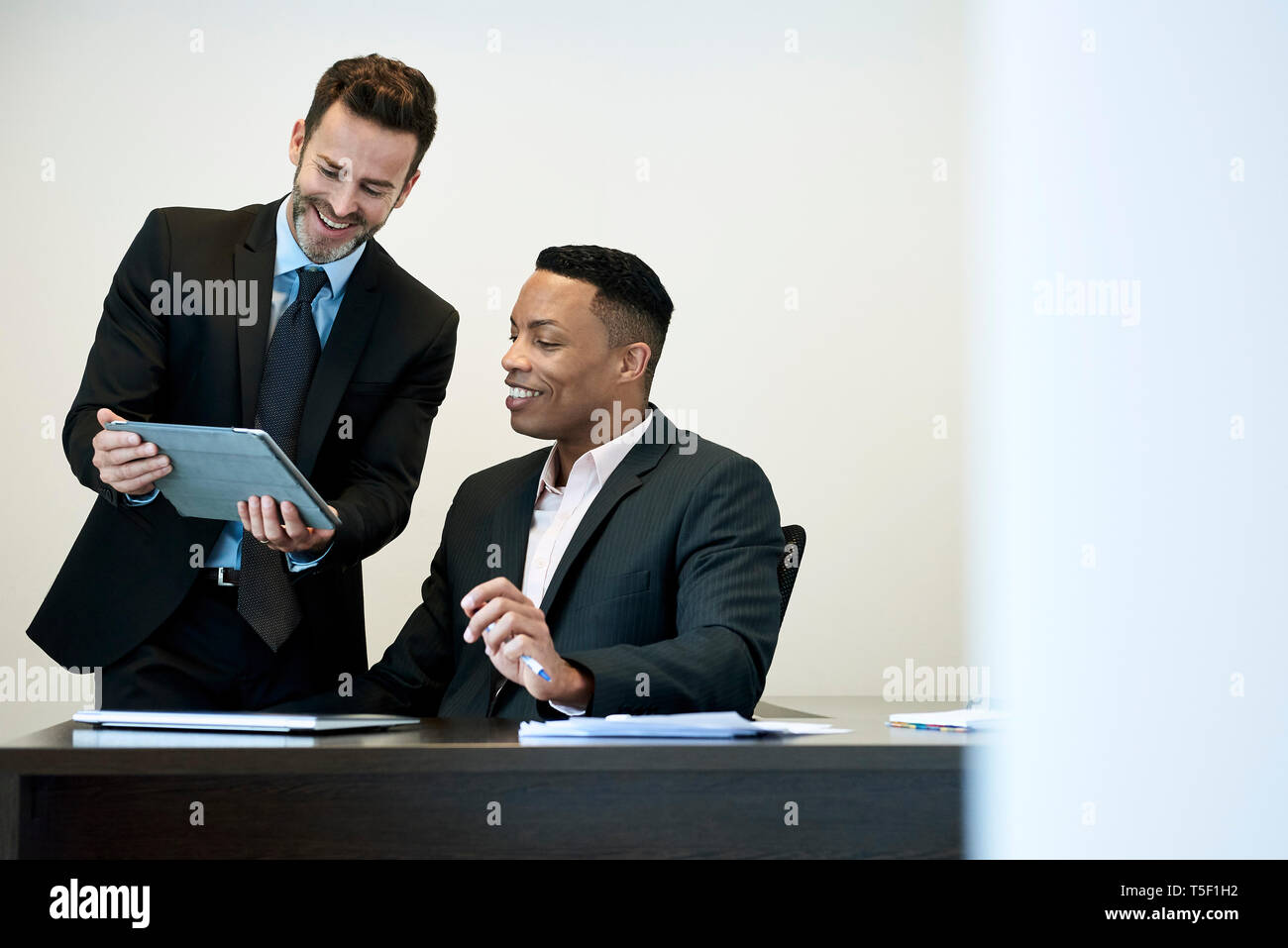 Businessmen using a digital tablet in office Stock Photo
