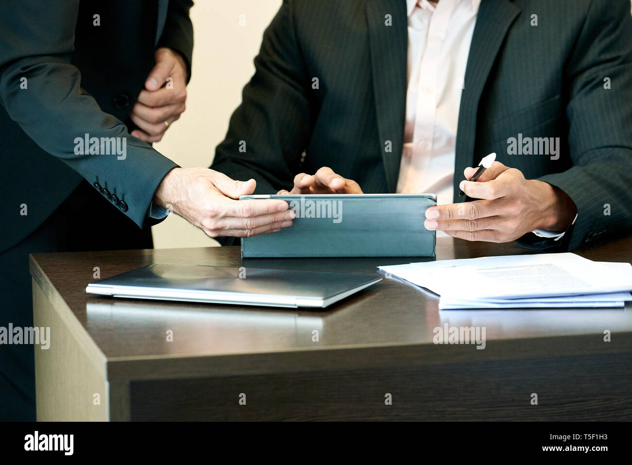 Businessmen using a digital tablet in office Stock Photo