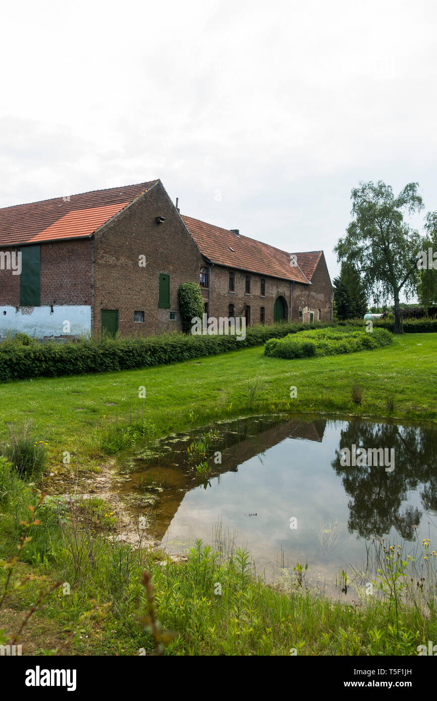 Dutch farm with pond in front, Simpelveld, Limburg, Netherlands. Stock Photo