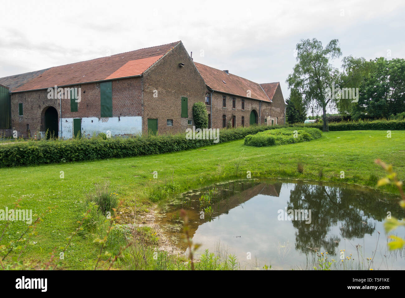 Dutch farm with pond in front, Simpelveld, Limburg, Netherlands. Stock Photo