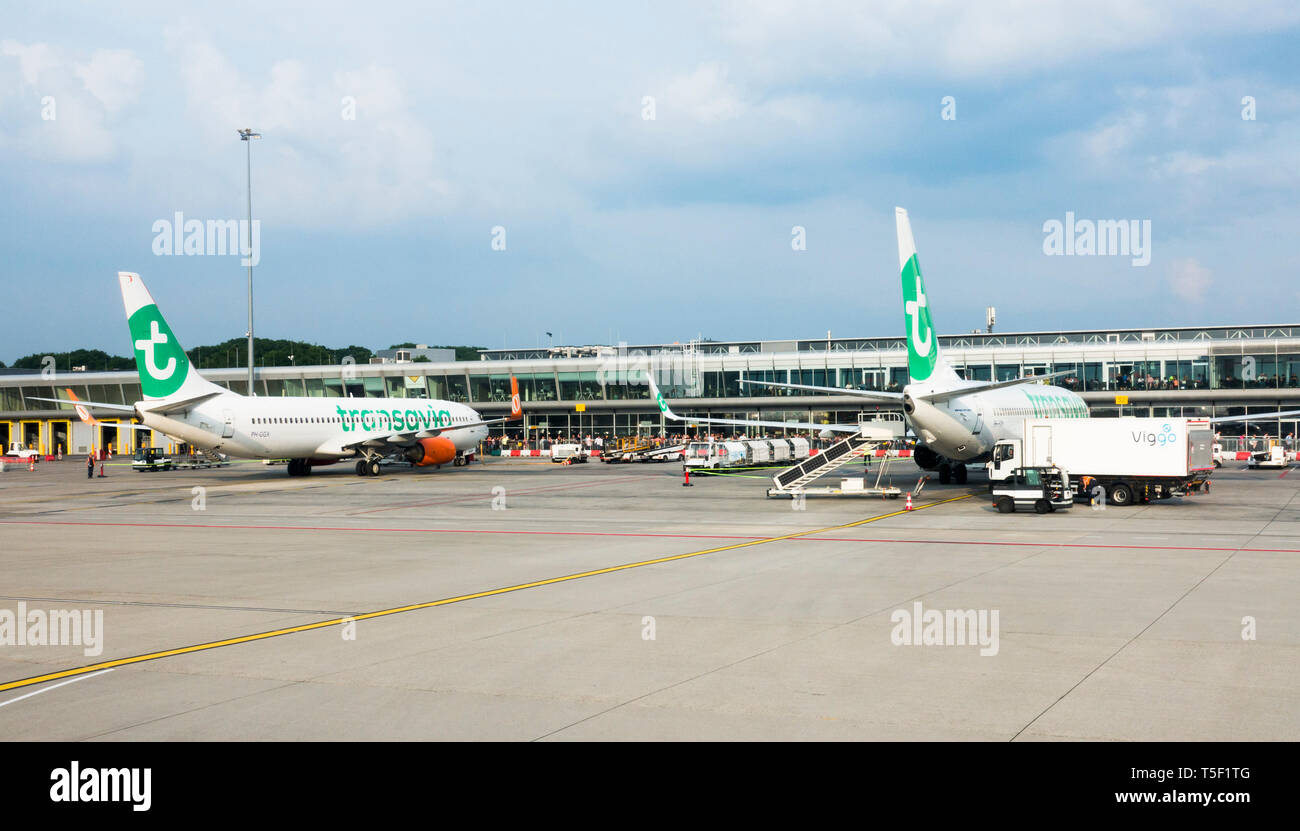 Two Transavia airlines aircrafts at gates Eindhoven airport. seen from runway, North Brabant, Netherlands Stock Photo
